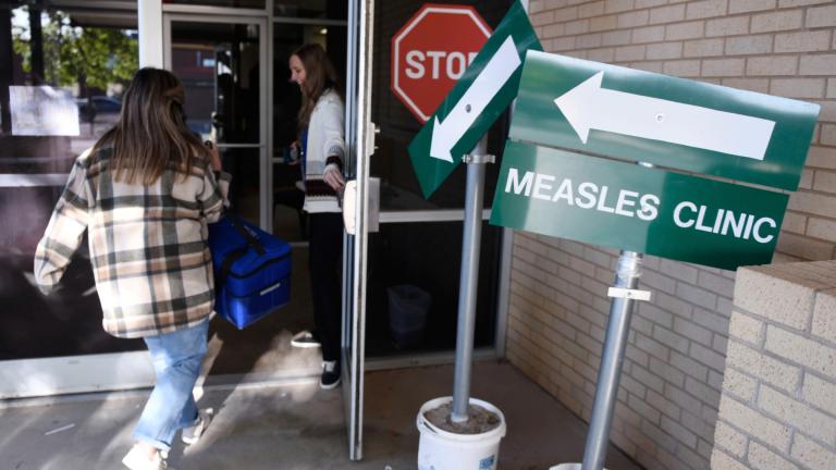 Health department staff members enter the Andrews County Health Department measles clinic carrying doses of the measles, mumps and rubella vaccine, Tuesday, April 8, 2025, in Andrews, Texas. (Annie Rice / AP Photo)
