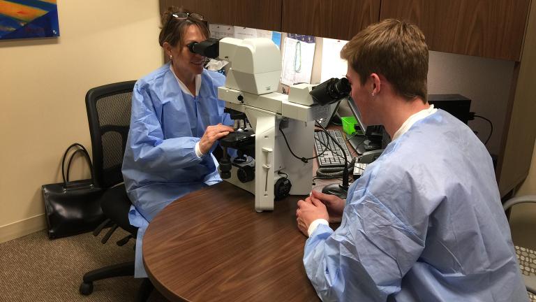 Pathologist Dr. Wendy Ward, left, and Zack Whitaker in the laboratory at Northwestern Medicine Huntley Hospital. (Courtesy of Northwestern Medicine)