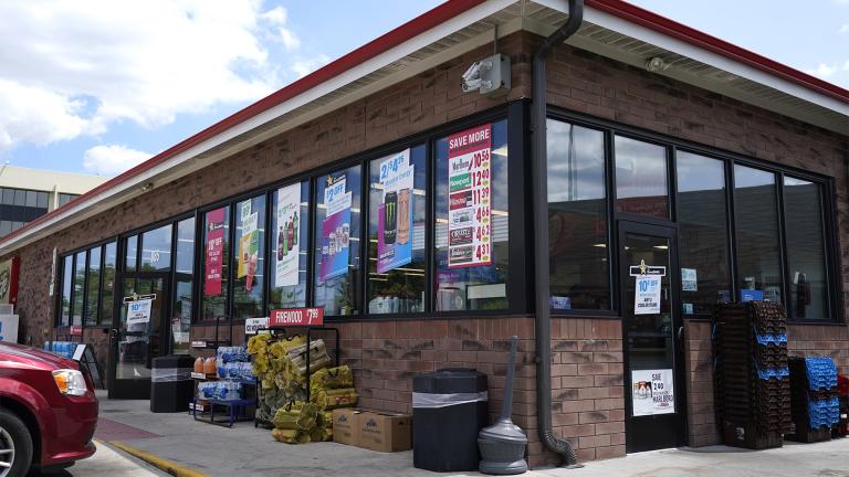 Vehicles are parked outside the Illinois Speedway gas station in Des Plaines, Ill., where the winning Mega Millions lottery ticket was sold, Saturday, July 30, 2022.  (AP Photo / Nam Y. Huh)