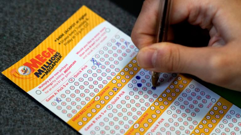 A customer fills out a Mega Millions lottery ticket at a convenience store Tuesday, Jan. 3, 2023, in Northbrook, Ill. (AP Photo / Nam Y. Huh)