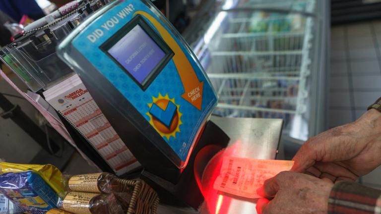 Roberto Ramirez checks his SuperLotto Plus ticket at a terminal at the gas station that previously sold the $2.04 billion-winning Powerball ticket award at Joe's Service Center, a Mobil gas station at Woodbury Road and Fair Oaks Avenue in Altadena, Calif., Friday, Jan. 6, 2023. (AP Photo / Damian Dovarganes)