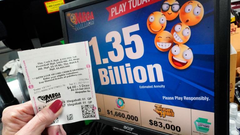 A customer at the Cranberry Super Mini Mart in Cranberry, Pa., shows her Mega Millions ticket on Thursday, Jan. 12, 2023. (AP Photo / Gene J. Puskar)