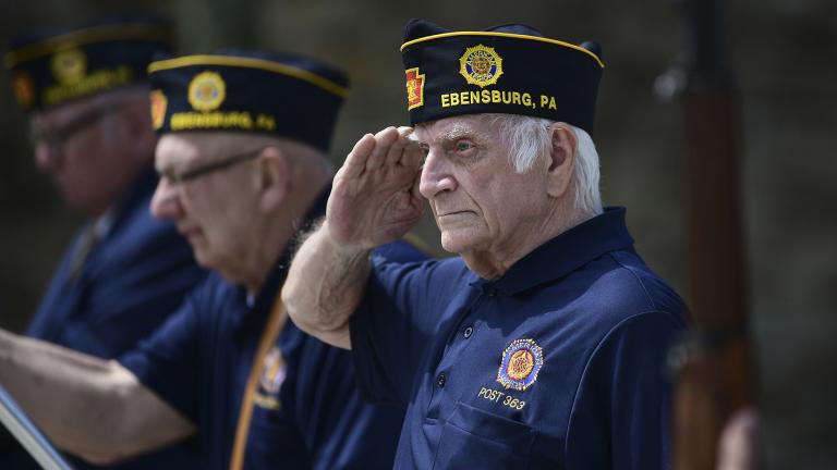 U.S. Army veteran Joseph Lesniak of Colver, Pa., salutes during the playing of Taps at a Memorial Day ceremony at Soldiers and Sailors Memorial Park, in Ebensburg, Pa., Monday, May 25. 2020. (John Rucosky / The Tribune-Democrat via AP)