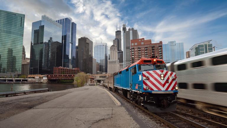 A Metra train is pictured against the Chicago skyline in a file photo. (Rudy Balasko / iStock)