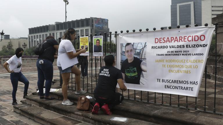 Family of Ricardo Valdes, who disappeared on the road on May 25, put up posters with their photography during a protest in Monterrey, Nuevo Leon state, Mexico, Thursday, June 24, 2021. (AP Photo / Roberto Martinez)