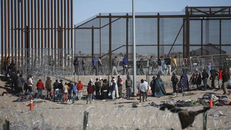Migrants line up after being detained by U.S. immigration authorities at the U.S. border wall, seen from Ciudad Juarez, Mexico, Wednesday, Dec. 27, 2023. (AP Photo / Christian Chavez)