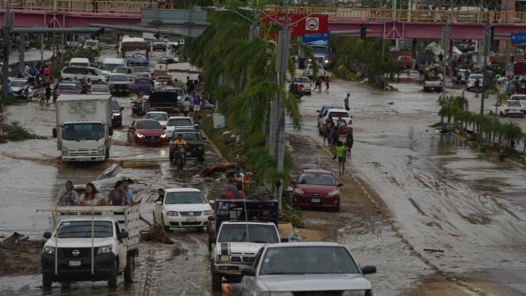 Cars cross a flood-damaged avenue after Hurricane Otis ripped through Acapulco, Mexico, Wednesday, Oct. 25, 2023. (Marco Ugarte / AP Photo)