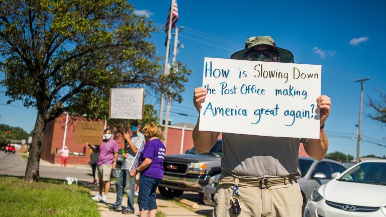 Eric Severson holds a sign as a few dozen people gather in front of the United States Post Office on Rodd St. to protest recent changes to the U.S. Postal Service under new Postmaster General Louis DeJoy on Tuesday, Aug. 11, 2020 in Midland, Mich. (Katy Kildee / Midland Daily News via AP) Eric Severson holds a sign as a few dozen people gather in front of the United States Post Office on Rodd St. to protest recent changes to the U.S. Postal Service under new Postmaster General Louis DeJoy on Tuesday, Aug. 11, 2020 in Midland, Mich. (Katy Kildee / Midland Daily News via AP)
