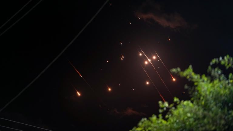 Missiles launched from Iran towards Israel streak across the night sky as seen from Deir al-Balah, Gaza Strip, Tuesday, Oct. 1, 2024. (AP Photo / Abdel Kareem Hana)