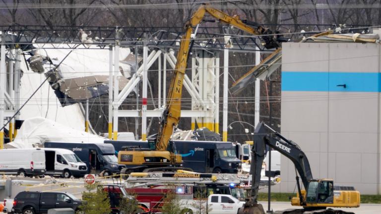 A heavily damaged Amazon fulfillment center is seen Saturday, Dec. 11, 2021, in Edwardsville, Ill. A large section of the roof of the building was ripped off and walls collapsed when strong storms moved through area Friday night. (AP Photo / Jeff Roberson)