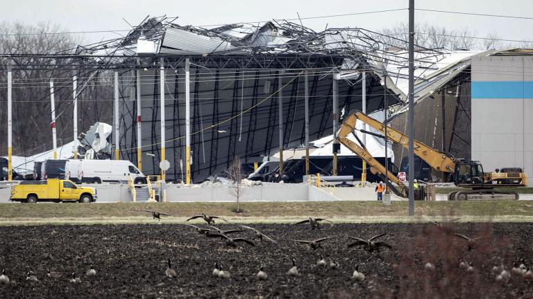 Crews move in heavy equipment for search and rescue operations at the Amazon distribution center in Edwardsville, Ill., on Saturday, Dec. 11, 2021. (Daniel Shular / St. Louis Post-Dispatch via AP)