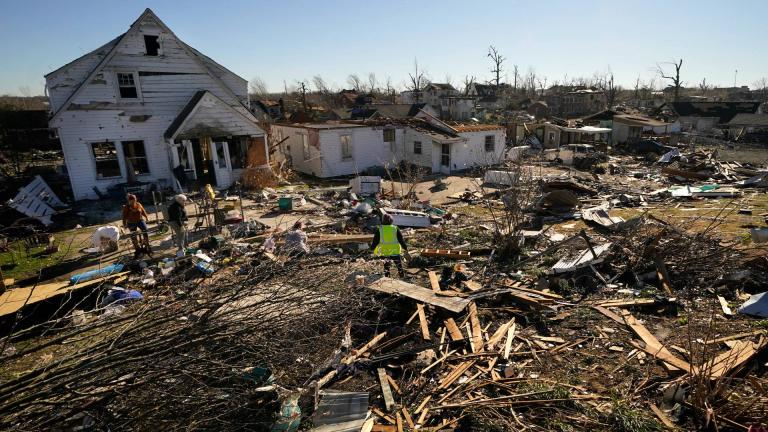Voluteers help Martha Thomas, second left, salvage possessions from her destroyed home, in the aftermath of tornadoes that tore through the region, in Mayfield, Ky., Monday, Dec. 13, 2021. (AP Photo/Gerald Herbert)
