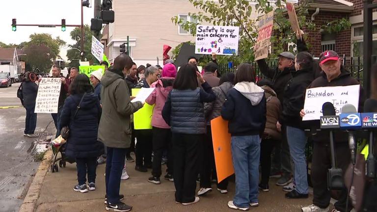 Protesters in front of a proposed base camp for migrants in Brighton Park on Oct. 19, 2023. (WTTW News via Pool)