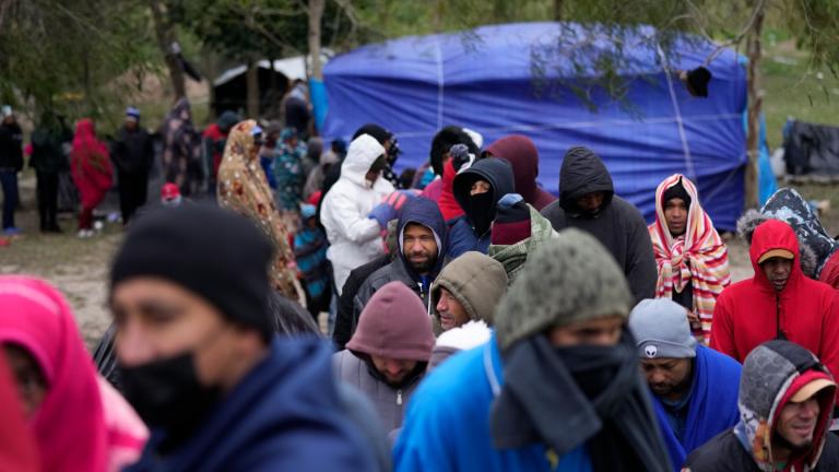 Migrants from Venezuela line up in the cold weather for hot drinks and food from volunteers at a makeshift camp on the U.S.-Mexico Border in Matamoros, Mexico, Friday, Dec. 23, 2022. (AP Photo / Fernando Llano, File)