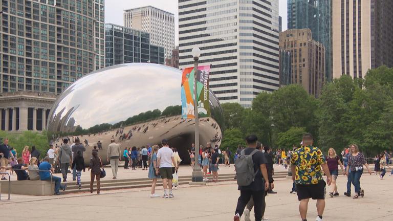 People walk through Millennium Park on May 20, 2022. (WTTW News)