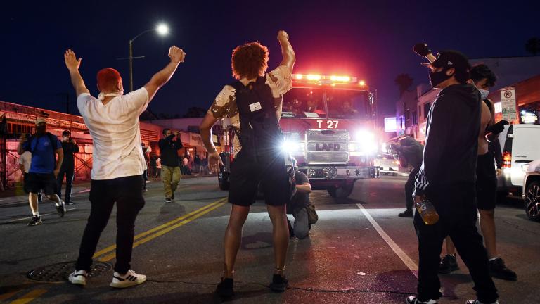 Demonstrators block the path of a Los Angeles Fire Department truck during a public disturbance on Melrose Avenue, Saturday, May 30, 2020, in Los Angeles. (AP Photo / Chris Pizzello)