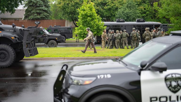 Law enforcement officers including local police, sheriffs and the FBI, stage less than a mile from a shooting in Brooklyn Park, Minn. on Saturday, June 14, 2025. (Alex Kormann / Star Tribune via AP)
