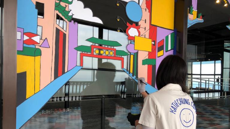 Artist Katie Chung paints a mural on the 94th floor of 875 North Michigan. (Marc Vitali / WTTW News)