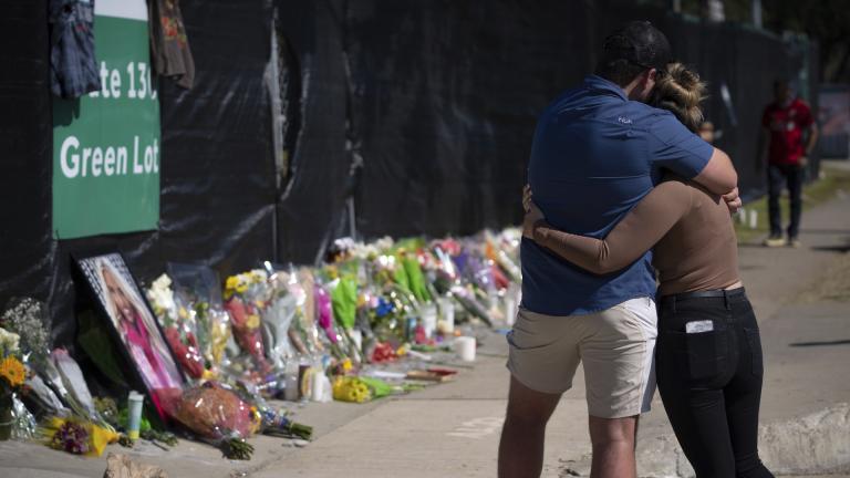 Two people who knew an unidentified victim of a fatal incident at the Houston Astroworld concert embrace at a memorial on Sunday, Nov. 7, 2021. (AP Photo/Robert Bumsted)