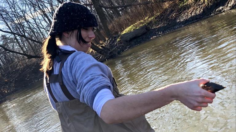 A volunteer pulls a freshwater mussel from the Chicago River, Dec. 12, 2023. (Patty Wetli / W