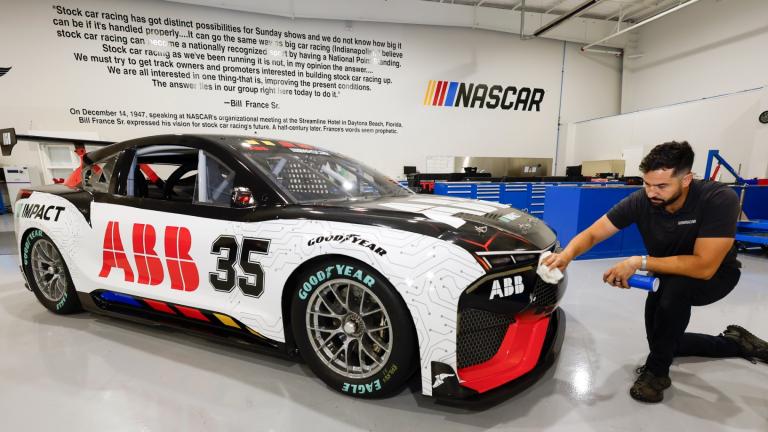 CJ Tobin, senior engineer of vehicle systems, cleans a prototype of the first electric racecar at the NASCAR R&D Center in Concord, N.C., Monday, July 1, 2024. (Nell Redmond / AP Photo)