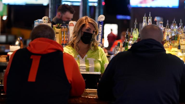 Jillian Smith takes an order from people at Kilroy’s Bar & Grill, Sunday, March 14, 2021, in Indianapolis. (AP Photo / Darron Cummings)