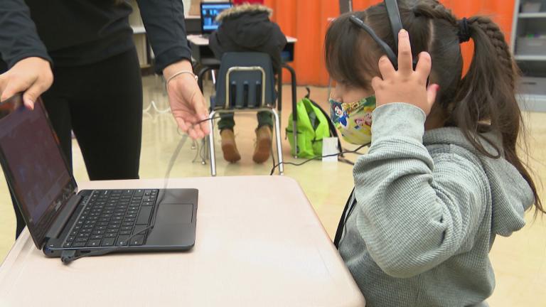 An elementary school student prepares to log onto her laptop for remote learning at A.J. Katenzmaier Academy in North Chicago on Oct. 30, 2020. (WTTW News)