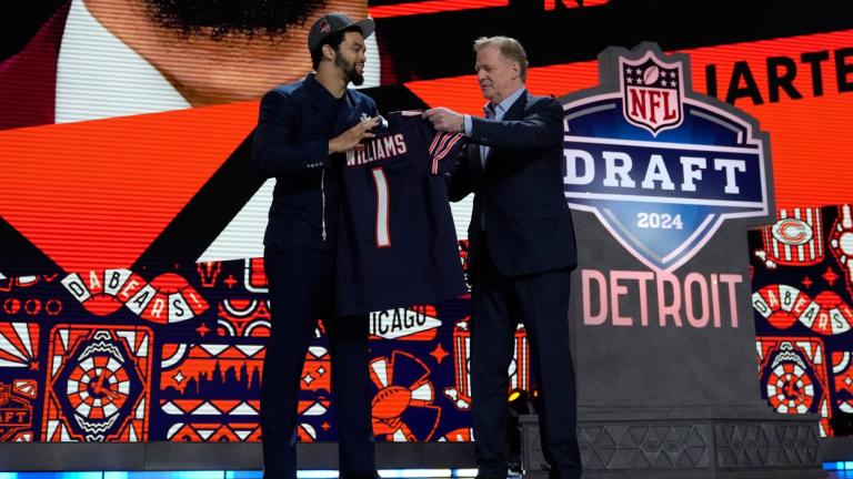 Southern California quarterback Caleb Williams celebrates with NFL commissioner Roger Goodell after being chosen by the Chicago Bears with the first overall pick during the first round of the NFL football draft, Thursday, April 25, 2024, in Detroit. (Jeff Roberson / AP Photo)