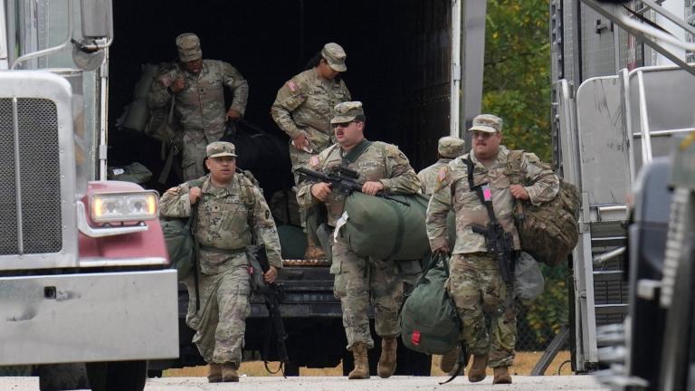 Military personnel in uniform, with the Texas National Guard patch on, are seen at the U.S. Army Reserve Center, Tuesday, Oct. 7, 2025, in Elwood, Ill., a suburb of Chicago. (AP Photo / Erin Hooley)