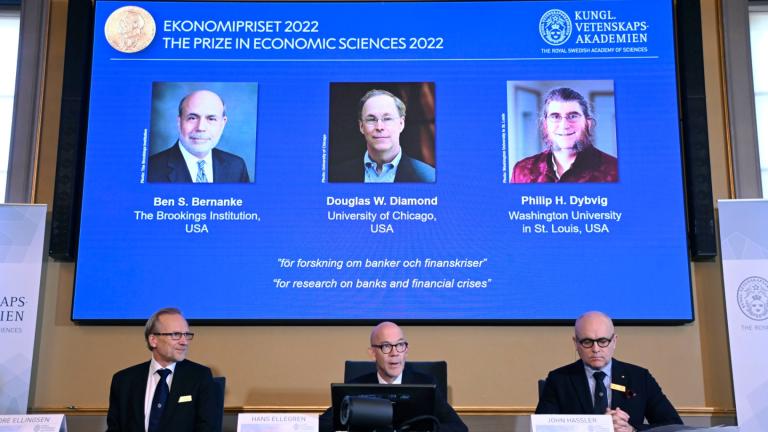From left, Tore Ellingsen, Hans Ellegren and John Hassler members of the Royal Swedish Academy of Sciences announce the Sveriges Riksbank Prize in Economic Sciences in Memory of Alfred Nobel 2022, during a press conference at the Royal Swedish Academy of Sciences in Stockholm, Sweden, Monday, Oct. 10, 2022. (Anders Wiklund / TT News Agency via AP)