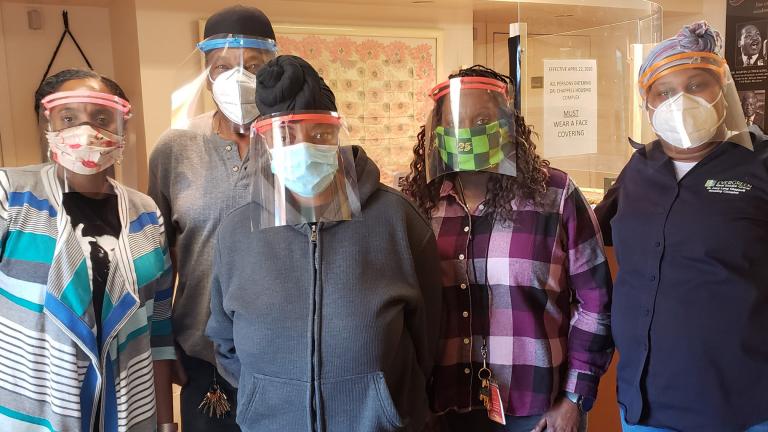 Employees of the Dr. Lucy Lang-Chappell Housing Complex in Chicago wear face shields provided by the “Noble Army.” (Courtesy of Rob and Susan Parks)