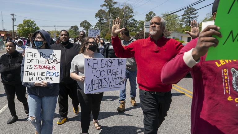 Kirk Rivers leads a group of demonstrators as they block Ehringhaus Street, a main retail avenue in Elizabeth City, N.C., Friday, April 23, 2021, as they demand after a fatal shooting that body camera video be released by the Pasquotank Sheriff’s office. (Robert Willett / The News & Observer via AP)