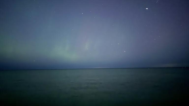 A faint view of the northern lights over Lake Michigan, near Foster Avenue beach, Oct. 10, 2024. (Patty Wetli / WTTW News)