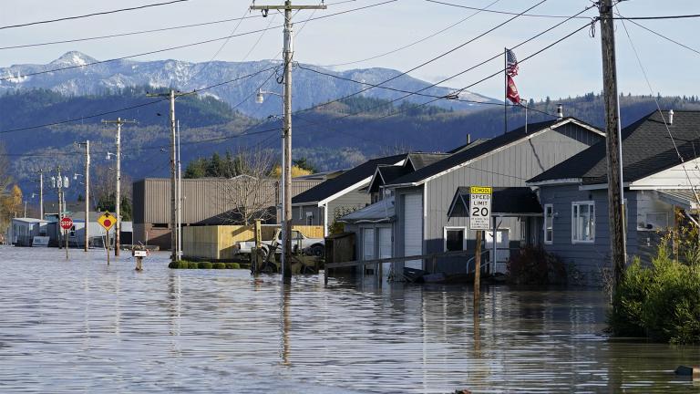 Floodwater inundates homes along a road on Nov. 17, 2021, in Sumas, Wash. Damages from flooding last week in northwest Washington's Whatcom County could reach as high as $50 million, officials said, as forecasters warn that multiple "atmospheric rivers" may drench the Pacific Northwest in coming days. (AP Photo / Elaine Thompson, File)