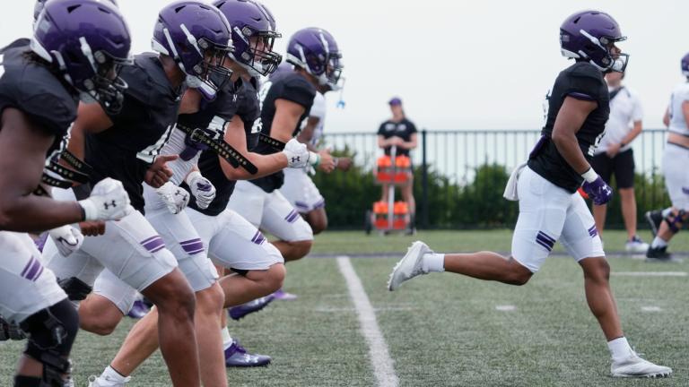 Northwestern football players warm up during team's practice in Evanston, Ill., Wednesday, Aug. 9, 2023. (Nam Y. Huh / AP Photo)