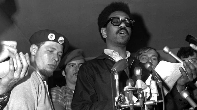 FILE - Puerto Rican Jose “Cha Cha” Jimenez, left, founder of the Young Lords in Chicago-area Puerto Rican group, attends a news conference led by Bobby Rush, deputy defense minister of the Illinois Black Panther party, in Chicago, June 4, 1969. (EK / AP Photo, File)