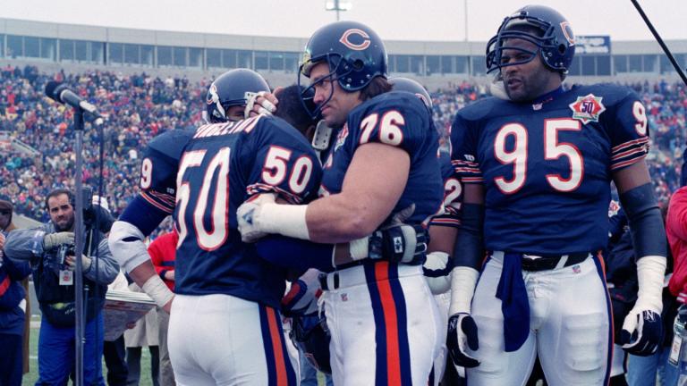 FILE - Chicago Bears nine-time Pro Bowler Mike Singletary (50) gets a bear hug from teammate Steve McMichael (76) prior to an NFL football game against the Pittsburgh Steelers in Chicago, Dec. 13, 1992. (AP Photo / David Boe, File)