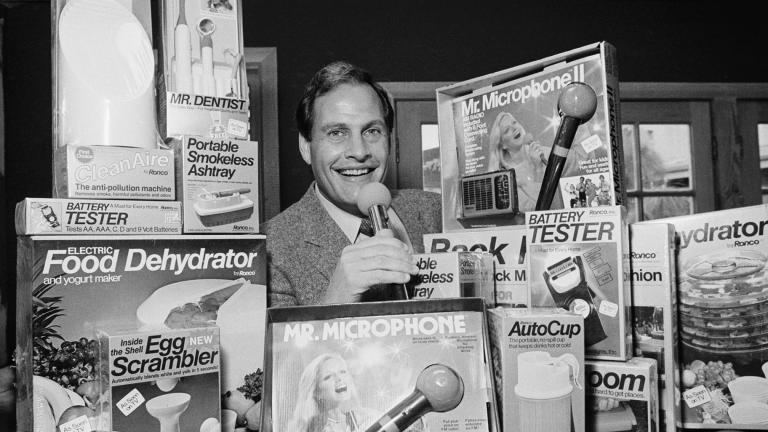 In this Wednesday, Dec. 8, 1982 file photo, Ron Popeil, the man behind those late-night, rapid-fire television commercials that sell everything from the Mr. Microphone to the Pocket Fisherman to the classic Veg-a-Matic, sits surrounded by his wares in his office in Beverly Hills, Calif. (AP Photo / Reed Saxon, File)