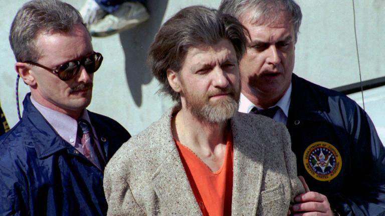Theodore "Ted" Kaczynski is flanked by federal agents as he is led to a car from the federal courthouse in Helena, Mont., April 4, 1996. (AP Photo / John Youngbear, File)