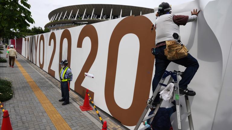 Workers paste the overlay on the wall of the National Stadium, where opening ceremony and many other events are scheduled for the postponed Tokyo 2020 Olympics, Wednesday, June 2, 2021, in Tokyo. (AP Photo / Eugene Hoshiko) Workers paste the overlay on the wall of the National Stadium, where opening ceremony and many other events are scheduled for the postponed Tokyo 2020 Olympics, Wednesday, June 2, 2021, in Tokyo. (AP Photo / Eugene Hoshiko)