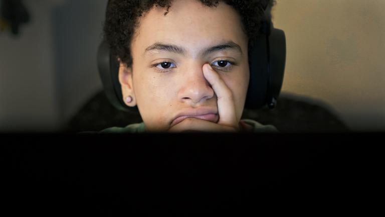 Miles Fallon works at his computer in his Chicago home Wednesday, Oct. 12, 2022. (AP Photo/Charles Rex Arbogast)