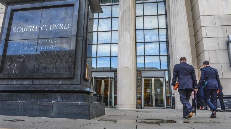 FILE - In this May 3, 2021, file photo, Huntington Mayor Steve Williams, left, and lawyer Rusty Webb enter the Robert C. Byrd United States Courthouse in Charleston, W. Va., for the start of the opioid trial. (Kenny Kemp / Charleston Gazette-Mail via AP, File)
