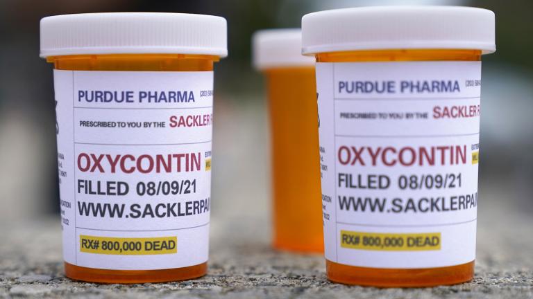 Fake pill bottles with messages about OxyContin maker Purdue Pharma are displayed during a protest outside the courthouse where the bankruptcy of the company is taking place in White Plains, N.Y., on Aug. 9, 2021. (AP Photo / Seth Wenig, File)