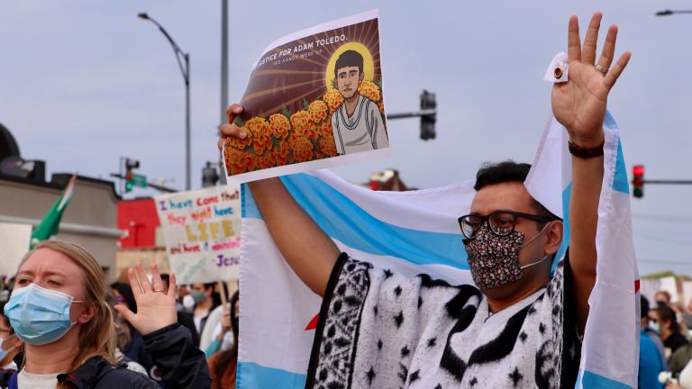 Little Village resident Andre Gordillo, right, raises his arms in protest during the Adam Toledo peace walk on April 18, 2021. “I think it’s important to show that I care about my community and that I want justice to be done for the wrongful murder of a 13-year-old,” Gordillo said. “This is a peaceful, youth-led march.” (Evan Garcia / WTTW News)