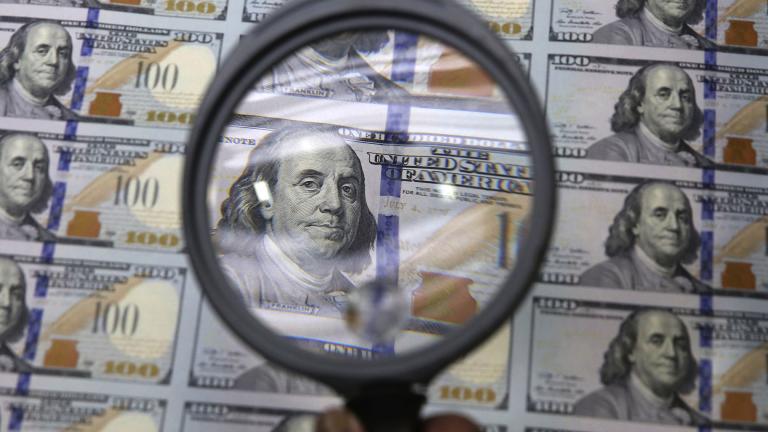 A sheet of uncut $100 bills is inspected during the printing process at the Bureau of Engraving and Printing Western Currency Facility in Fort Worth, Texas, on Sept. 24, 2013. (AP Photo / LM Otero, File)
