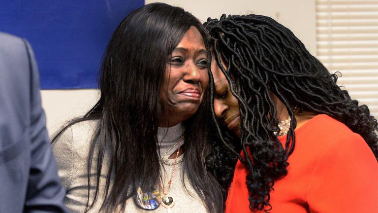 Rosena Washington, left, mother of Earl Moore Jr., and NAACP Springfield, Ill., branch president and state director Teresa Haley, comfort each other during a news conference, Thursday Jan. 19, 2023, in Springfield. Moore's family has filed a lawsuit against the two paramedics and their employer in the death of Moore, attorneys said Thursday. (Thomas Turney / The State Journal-Register via AP)