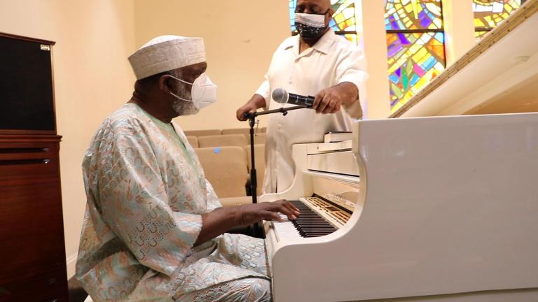 Pastor T. L Barrett sings as Dwayne Barrett, the drummer of his choir, adjusts his microphone at the pastor’s South Side Pentecostal church on Sunday, July 12, 2020. (Evan Garcia / WTTW News)