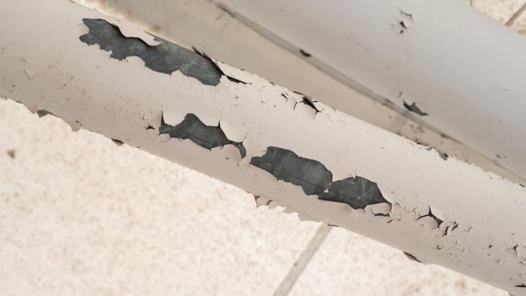 Lead paint chips off a pipe. (James Ebanks / iStock) 