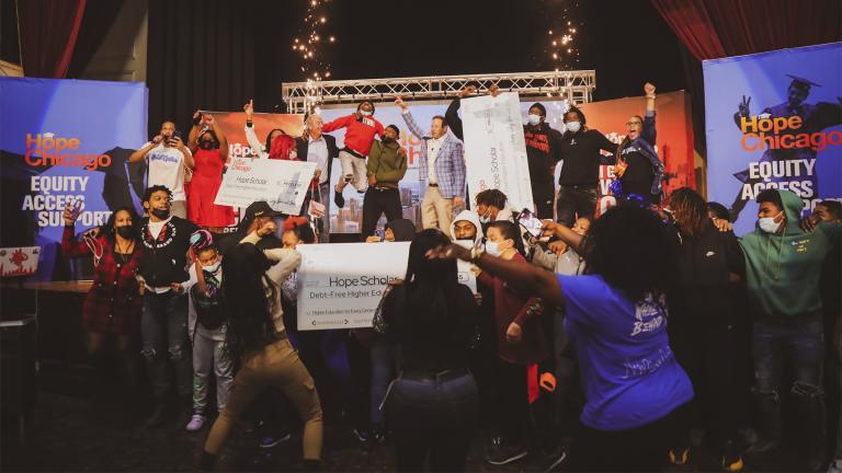 In this image provided by Hope Chicago, students at Raby High School in Chicago celebrate on Feb. 22, 2022, after they were told by Hope Chicago, they were receiving full, debt-free college scholarships to partner colleges and universities. (Hope Chicago via AP)