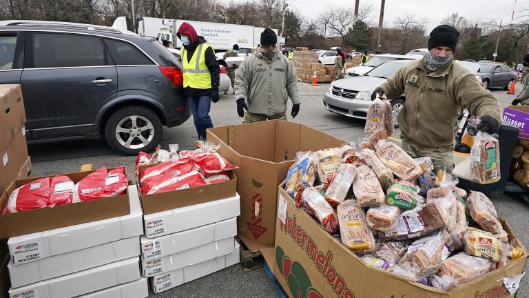 Sgt. Kevin Fowler organizes food at a food bank distribution by the Greater Cleveland Food Bank, Thursday, Jan. 7, 2021, in Cleveland. (AP Photo / Tony Dejak File)
